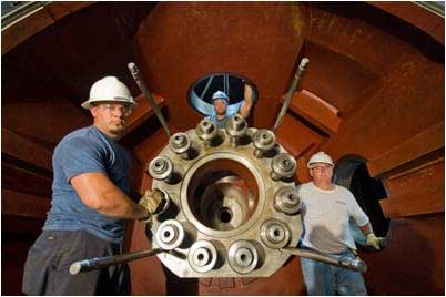 Workers rehabilitating a runner hub at American Electric Power’s Racine Hydro Station. Photo courtesy Voith Hydro